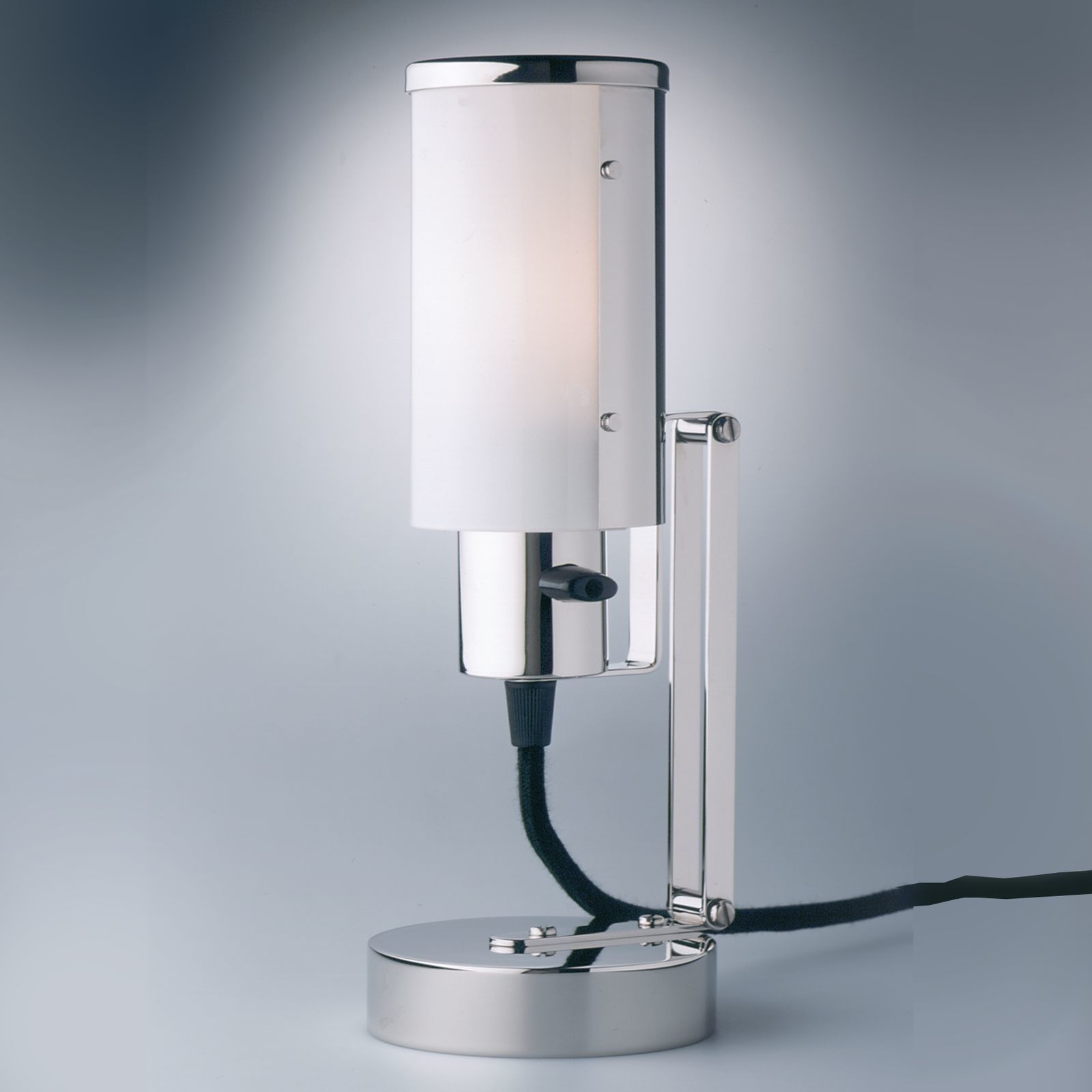 "Nachttischlampe, auch als Wandleuchte verwendbar" war die ursprüngliche Bezeichnung dieser Leuchte im Prospekt der Weimar Bau- und Wohnungskunst GmbH.Wilhelm Wagenfeld entwarf 1930